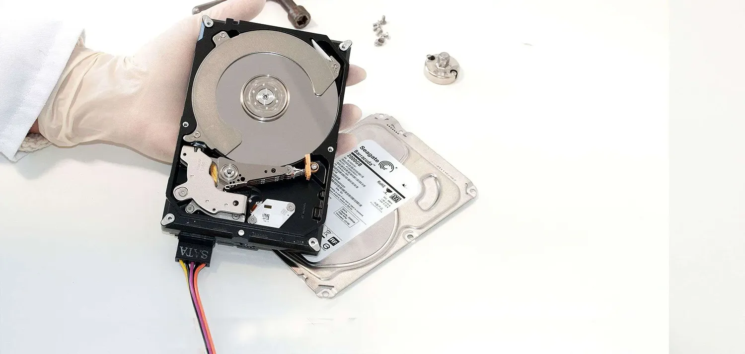 a hand holding a hard drive
