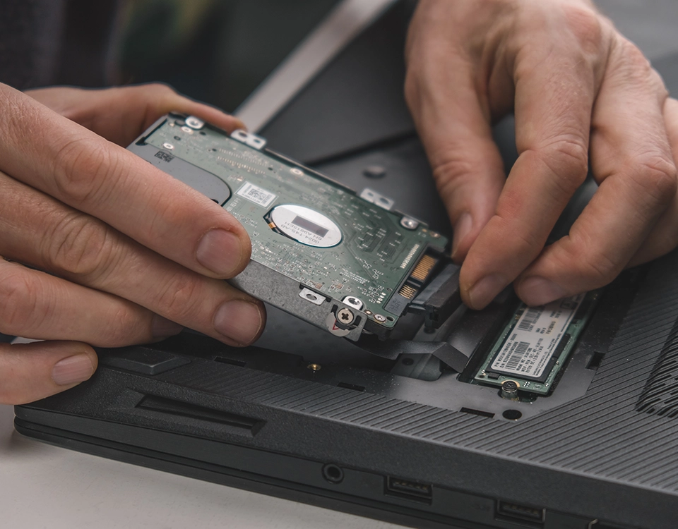 a person holding a hard drive