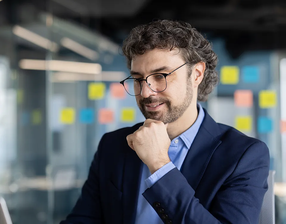 a man in a suit and glasses