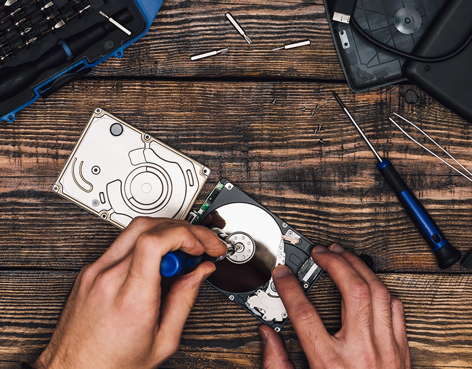 a person fixing a hard drive