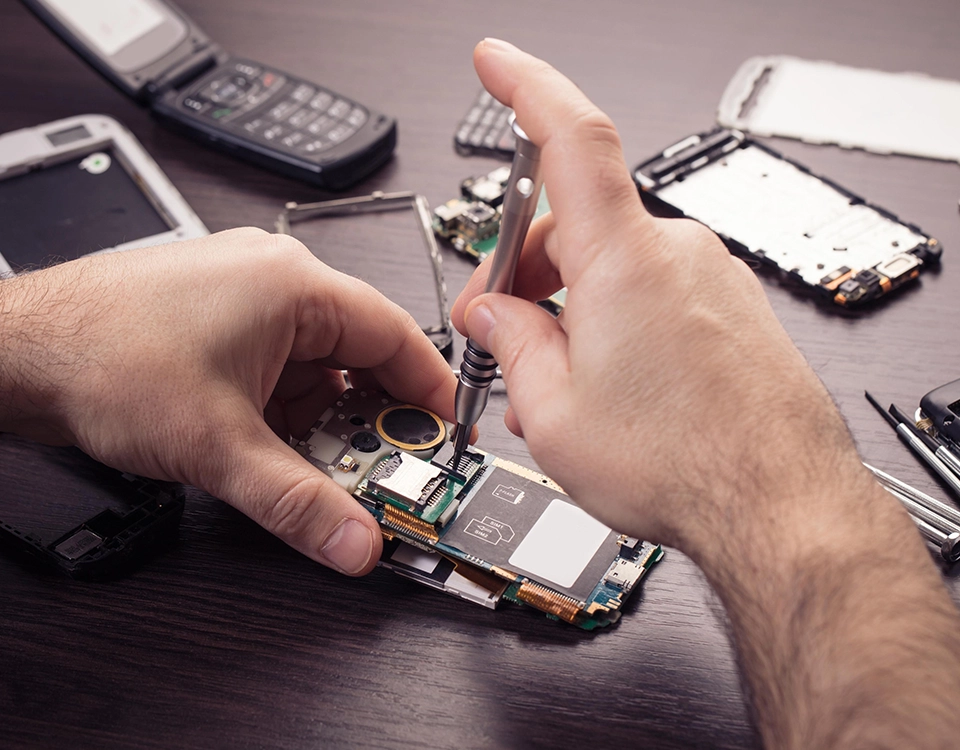 a person fixing a cell phone