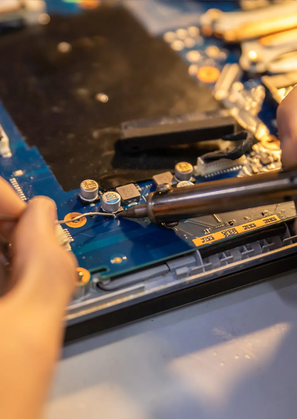 a person holding a soldering iron